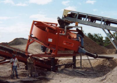 An operator of a sand manufacturing operation performs an inspection of an Ortner sand dewatering and classifying machine.